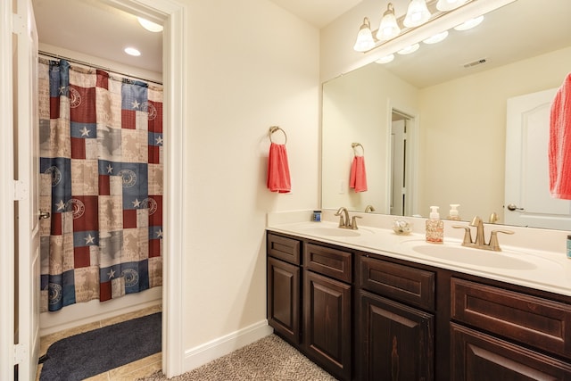 bathroom featuring dual sinks and large vanity