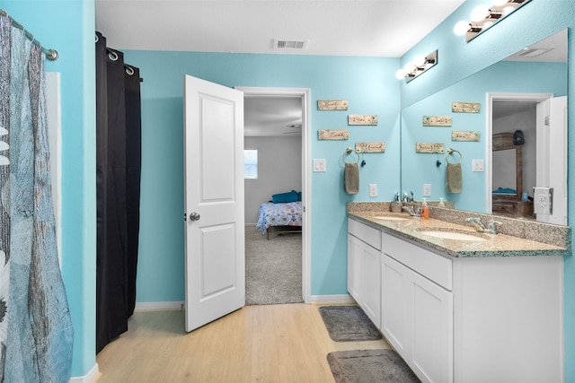 bathroom with vanity and hardwood / wood-style floors