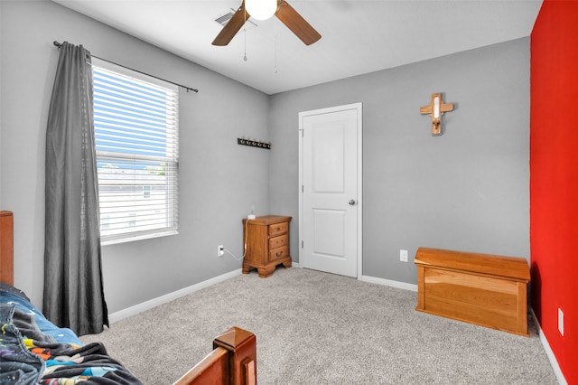 carpeted bedroom featuring multiple windows and ceiling fan