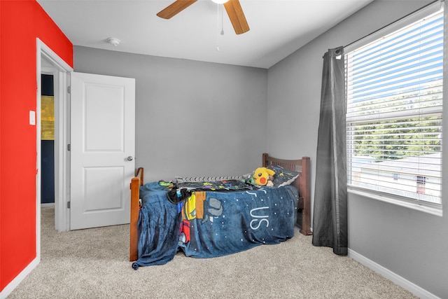 bedroom featuring light colored carpet and ceiling fan