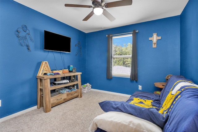 sitting room with ceiling fan and light carpet