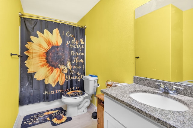 bathroom featuring a shower with curtain, toilet, and vanity