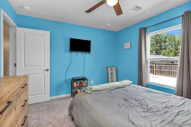 bedroom with ceiling fan and light carpet