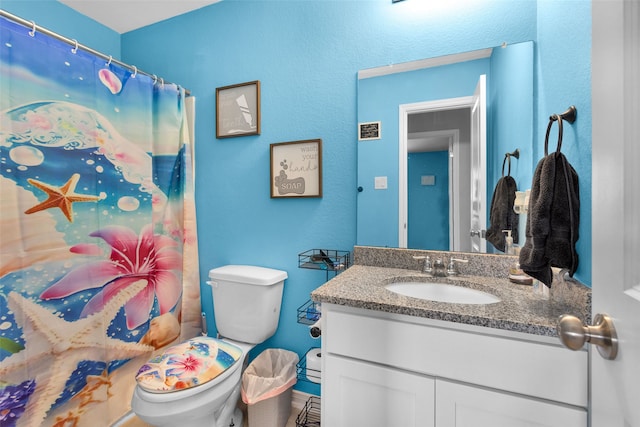 bathroom with vanity, toilet, and a shower with shower curtain