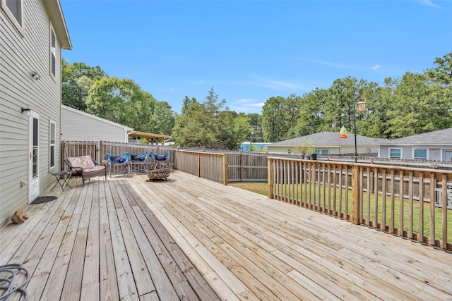 wooden terrace featuring a lawn