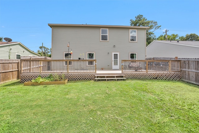 back of property with a wooden deck and a yard