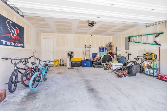 garage featuring electric panel and a garage door opener