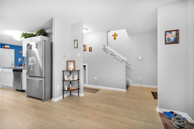 interior space with sink and light wood-type flooring