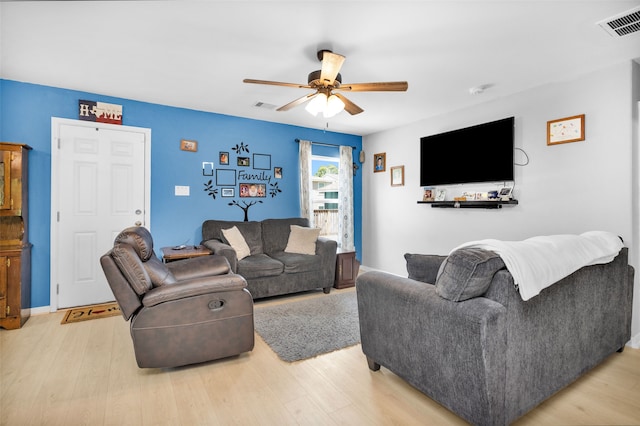 living room with light wood-type flooring and ceiling fan