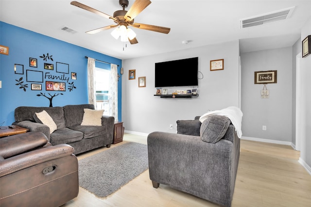 living room with ceiling fan and light wood-type flooring