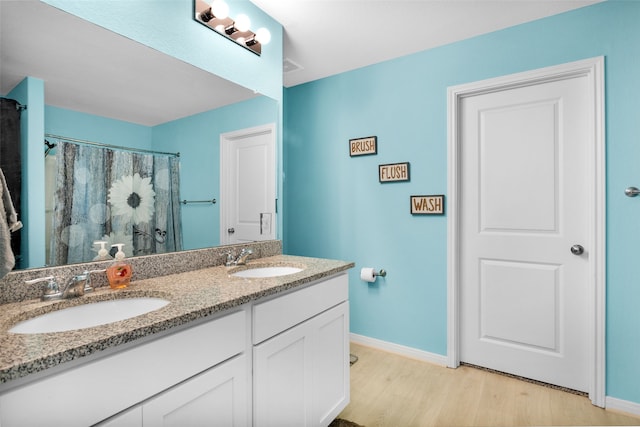 bathroom with hardwood / wood-style flooring and vanity