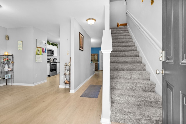 stairs with hardwood / wood-style floors