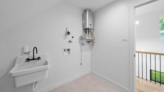 clothes washing area featuring sink, hookup for a washing machine, and water heater