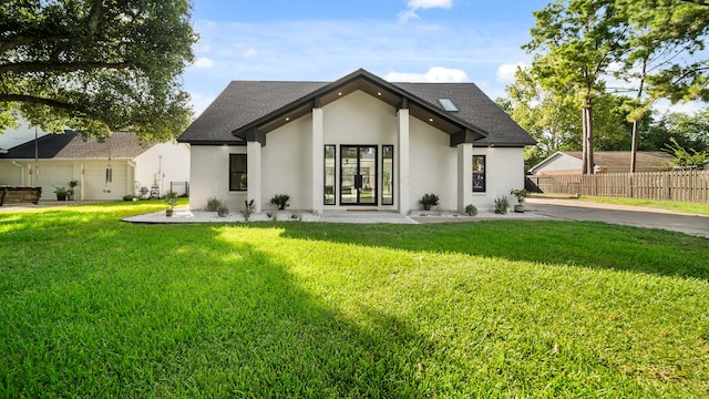 rear view of property featuring a lawn