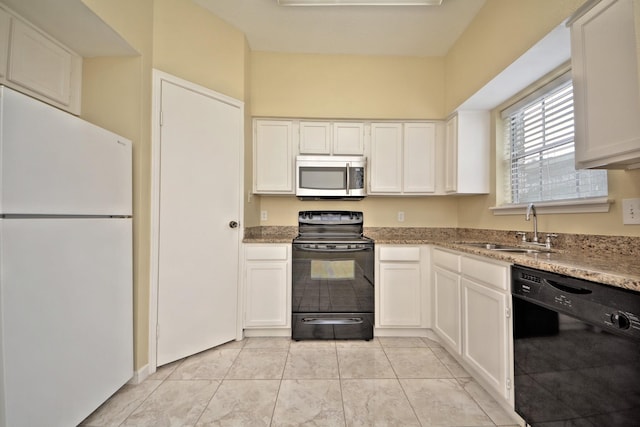 kitchen with black appliances, light stone countertops, white cabinets, sink, and light tile floors