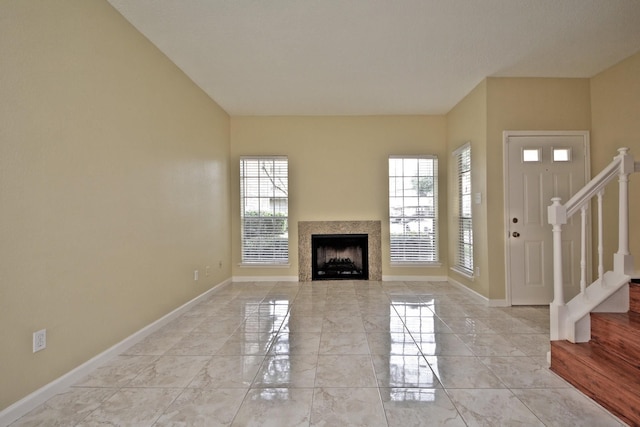 unfurnished living room featuring light tile flooring