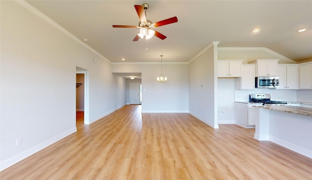 kitchen with crown molding, light hardwood / wood-style flooring, white cabinets, and stove