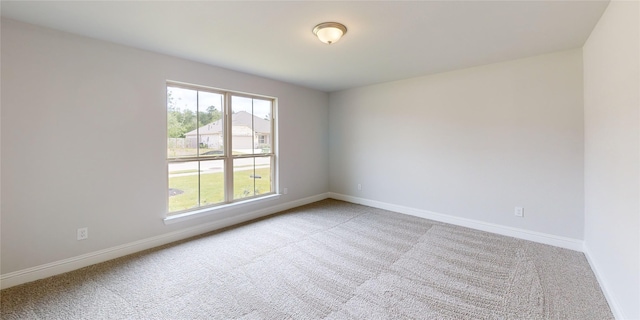 spare room with light colored carpet