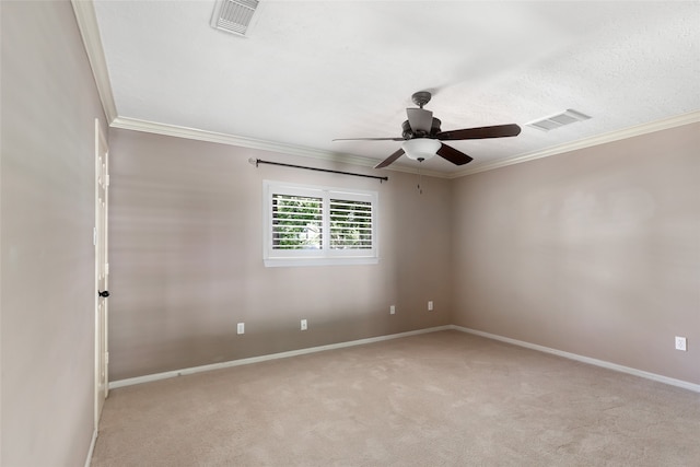 spare room featuring crown molding, carpet, and ceiling fan