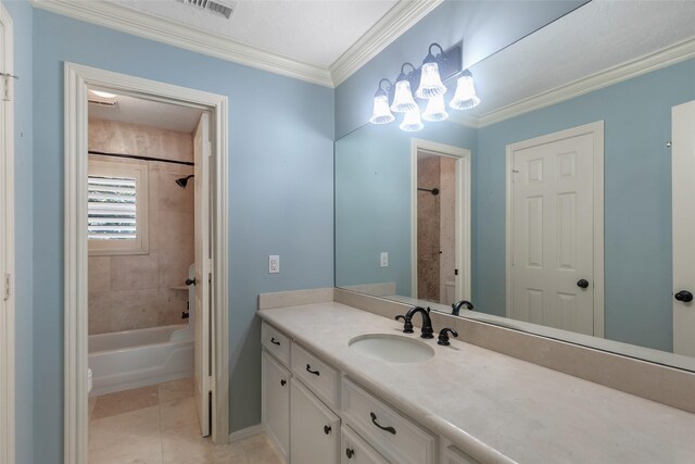 bathroom with crown molding, tile floors, a chandelier, tiled shower / bath combo, and large vanity