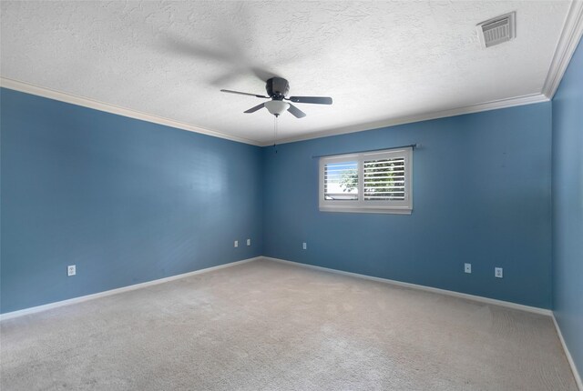 carpeted spare room with ceiling fan, a textured ceiling, and crown molding