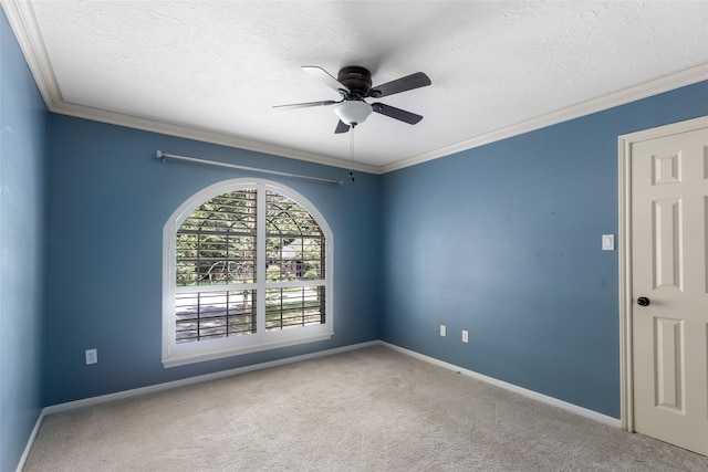 spare room featuring a textured ceiling, ornamental molding, carpet, and ceiling fan