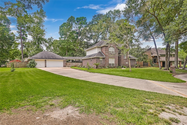 traditional-style house with a garage, brick siding, fence, concrete driveway, and a front yard