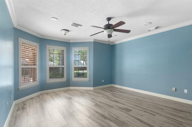 unfurnished room with a textured ceiling, ornamental molding, wood-type flooring, and ceiling fan