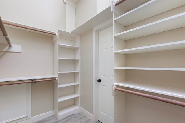 walk in closet with light wood-type flooring