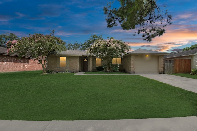 single story home with a yard and a garage