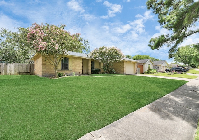 ranch-style home with a garage and a front yard