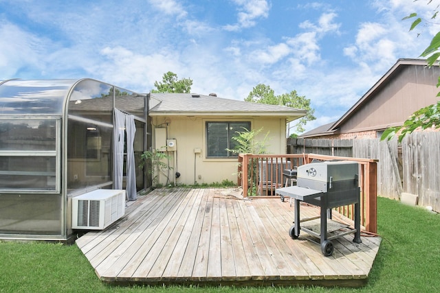 wooden terrace featuring a lawn and an outbuilding