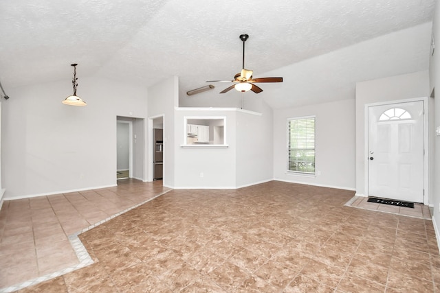 unfurnished living room featuring a textured ceiling, ceiling fan, tile patterned flooring, and vaulted ceiling