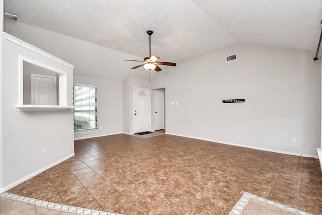 unfurnished living room with a textured ceiling, tile patterned floors, ceiling fan, and lofted ceiling