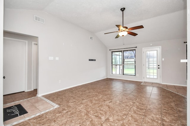 unfurnished living room with tile patterned flooring, a textured ceiling, vaulted ceiling, and ceiling fan