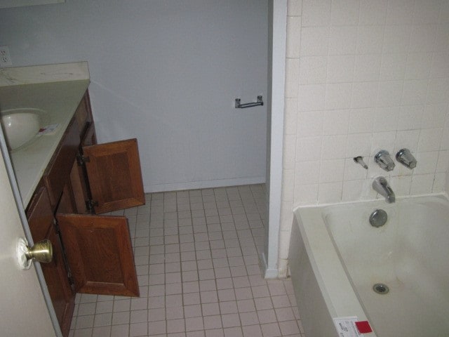 bathroom featuring tile flooring, shower / washtub combination, and vanity