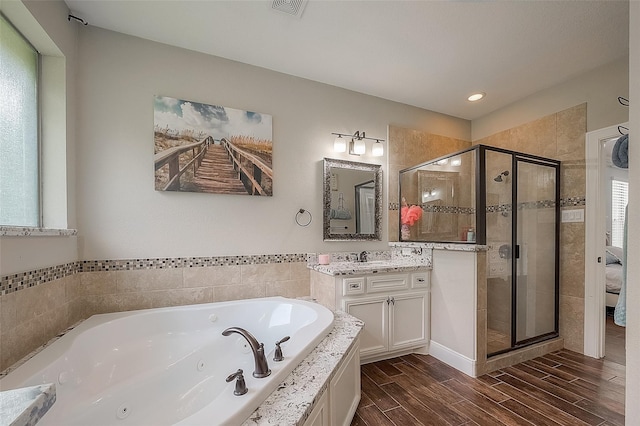 bathroom with separate shower and tub and vanity