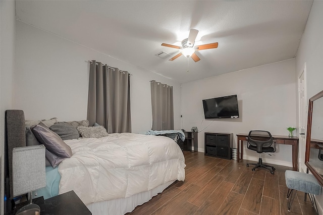 bedroom with dark hardwood / wood-style floors and ceiling fan