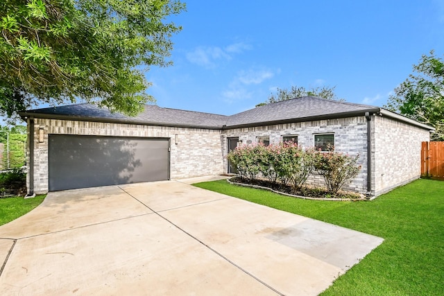 view of front of house with a garage and a front yard