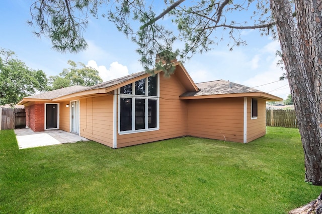 back of house featuring a yard and a patio area