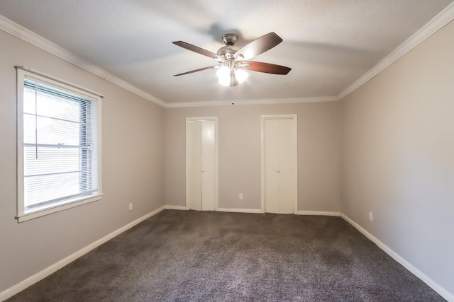 unfurnished bedroom with dark colored carpet, ceiling fan, and crown molding