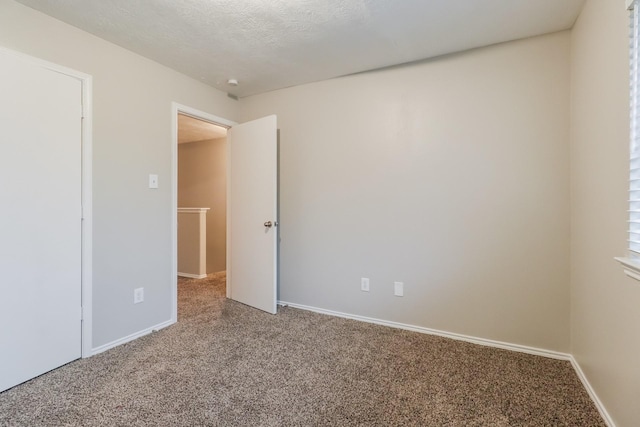 unfurnished room featuring a textured ceiling