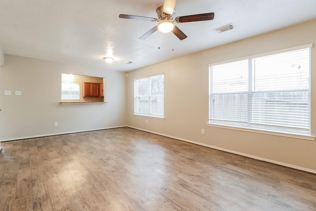 unfurnished living room featuring ceiling fan and light wood-type flooring