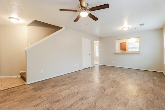 unfurnished living room with light hardwood / wood-style flooring and ceiling fan