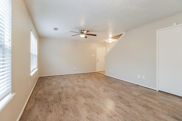 empty room featuring ceiling fan and light wood-type flooring