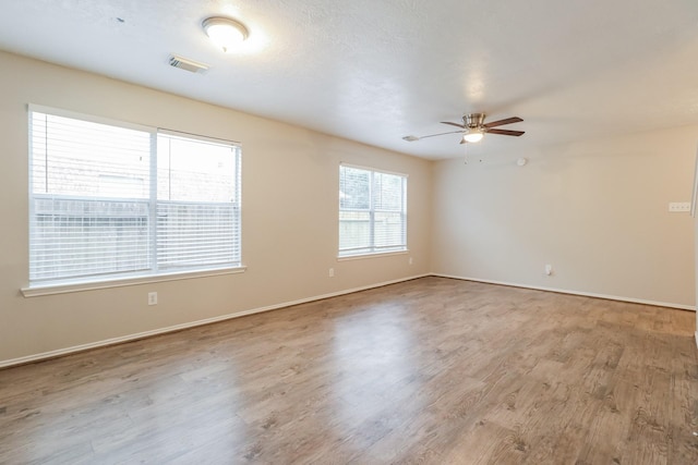 unfurnished room featuring ceiling fan and light hardwood / wood-style flooring