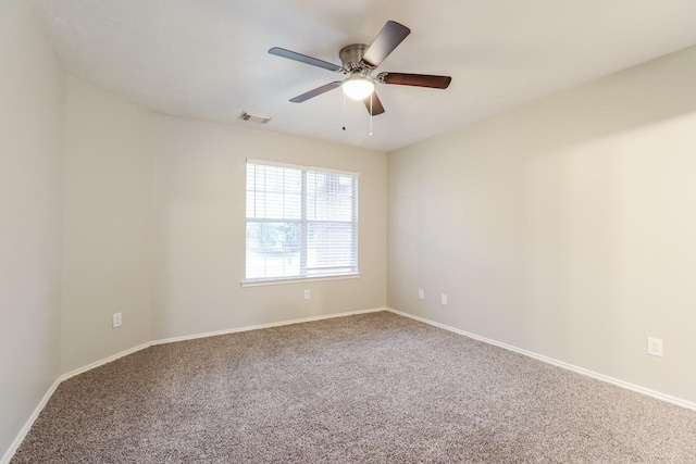 carpeted spare room featuring ceiling fan