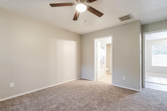 spare room with ceiling fan and light colored carpet