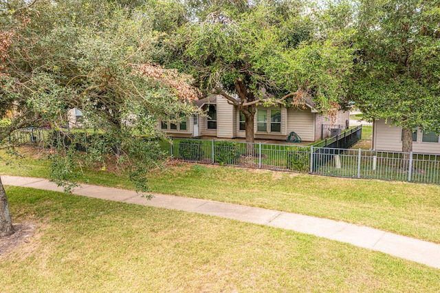 view of front of house with fence and a front lawn