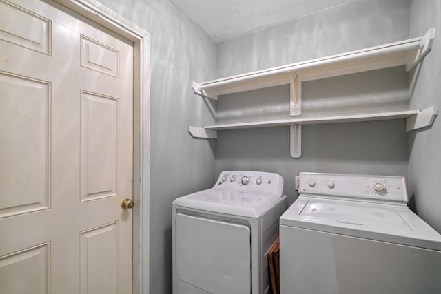 clothes washing area featuring washer and dryer and laundry area